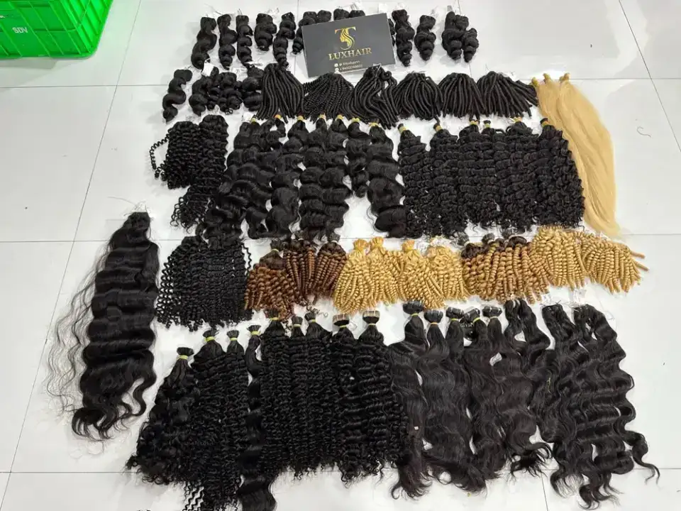 Bundles of curly, wavy and blonde hair laid out by texture at our workshop in Vietnam